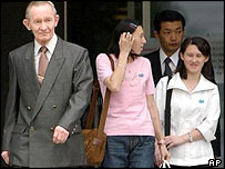 Mr Jenkins and his two daughters leave hospital in Tokyo for the US military base